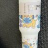 Colorful Stitch-themed foam tumbler with cartoon characters.