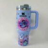Bright blue coffee tumbler with Stitch design and handle.
