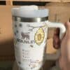 Bee and honeycomb design on Stanley insulated travel mug for coffee lovers.