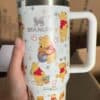 Cute Winnie the Pooh-themed travel mug with Disney characters, Starbucks style.
