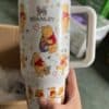 Bright Winnie the Pooh themed travel mug with cartoon characters, perfect for gift or daily use.