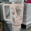 Cute Winnie the Pooh tea tumbler with floral and bee design.