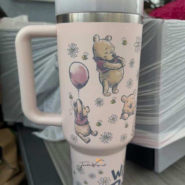 Cute Winnie the Pooh tea tumbler with floral and bee design.