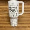 White Stanley thermal mug with Winnie the Pooh illustration and design.