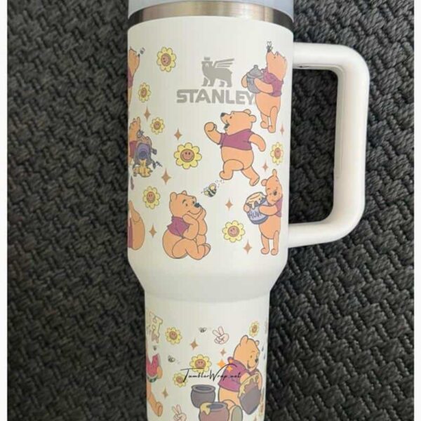 Cute Winnie the Pooh-themed insulated travel mug with adorable characters and floral accents.