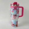 Pink cute bunny travel mug with floral design and cartoon characters.