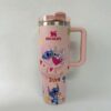 Pink Stitch coffee tumbler with hearts and Stitch characters.