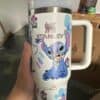 Cute Stitch character travel tumbler with floral and rainbow decor.