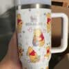 Unique Winnie the Pooh insulated travel mug with cartoon illustrations.