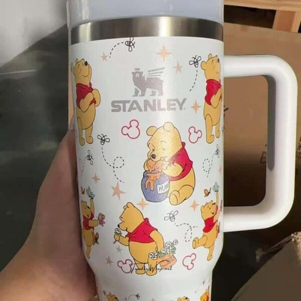Unique Winnie the Pooh insulated travel mug with cartoon illustrations.