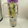 Colorful Halloween-themed coffee mug with spooky characters and pumpkins.