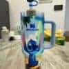 Colorful Disney Stitch water tumbler with straw and lid.