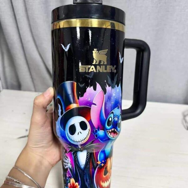 Bright Halloween-themed reusable tumbler with skull and monster graphics.