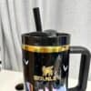 Reusable travel mug with Stanley logo and colorful unicorn design.