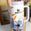 Halloween-themed mug featuring Stitch character, bats, spider web, and skull design.