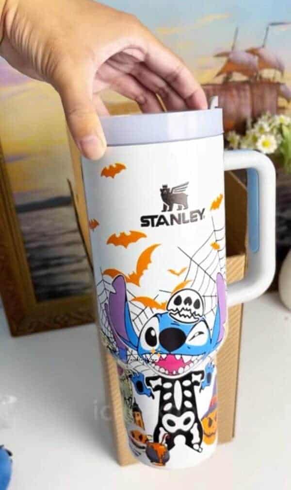 Halloween-themed mug featuring Stitch character, bats, spider web, and skull design.