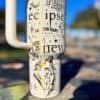 Decorative mug with eclipse, mountains, and romantic illustrations.