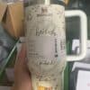 A Stanley tumbler with Winnie the Pooh and friends, promoting luck and happiness.