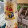 Colorful Pooh and friends cartoon beverage cup with butterflies.