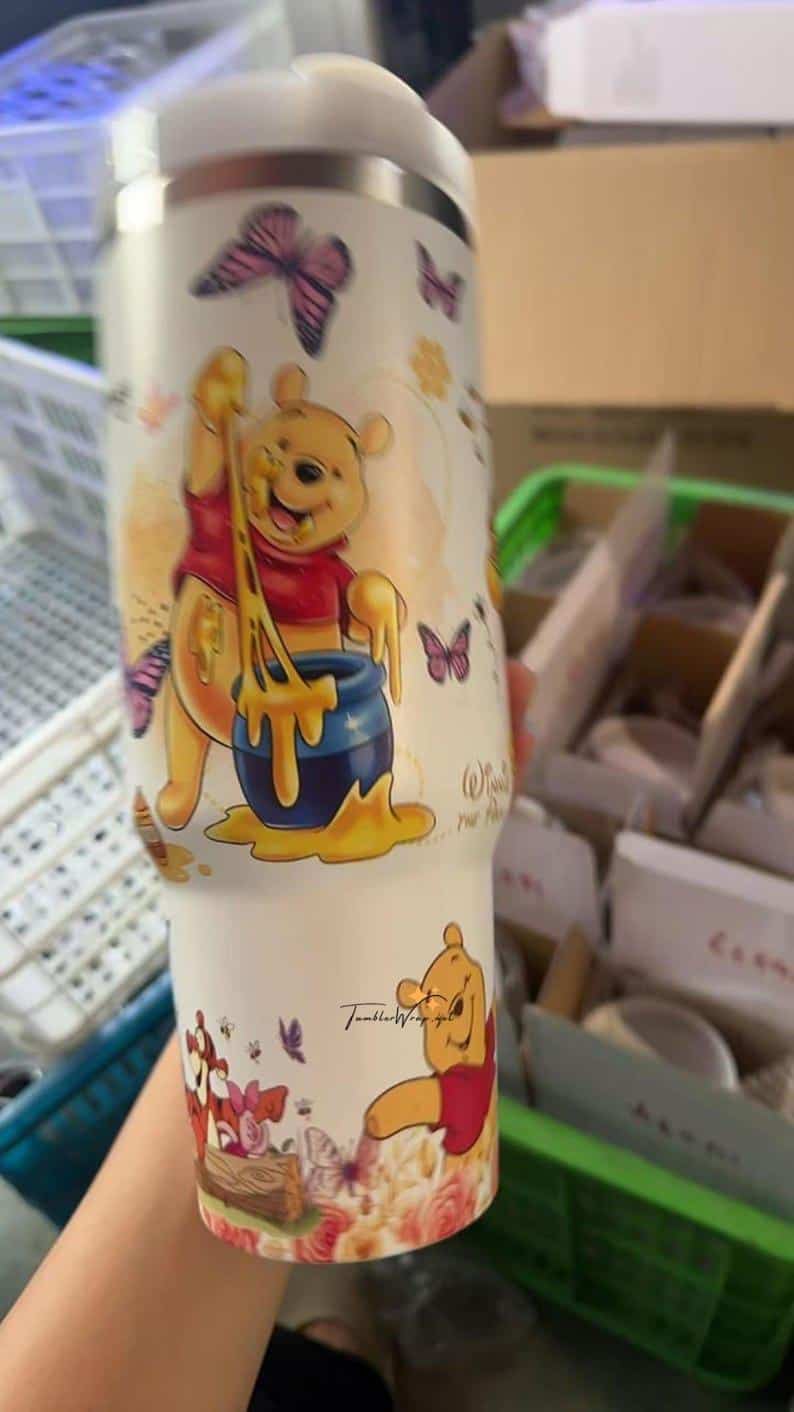 Colorful Pooh and friends cartoon beverage cup with butterflies.