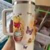 Colorful Winnie the Pooh themed honey mug featuring cartoon characters and bees.