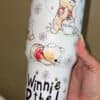 Adorable Winnie the Pooh sticker featuring bees and floral accents for kids.