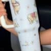 Winnie the Pooh themed coffee mug with floral and bee illustrations, perfect for gifts.