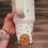 Bright mug featuring honey jar, bees, and honey dripping illustration.