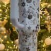 Decorative white travel mug with Disney characters and festive holiday illustrations.