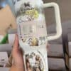 Colorful eco-friendly insulated water bottle with outdoor scene artwork and inspiring message.