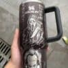 Dark travel mug with horror-themed graphic design, including a screaming face & clown.