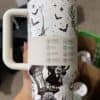 Bright ceramic mug featuring Halloween witch and haunted house designs.