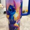 Colorful Disney Stitch mug with sunset scene.