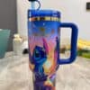 Bright Disney Stitch travel mug with tropical design.