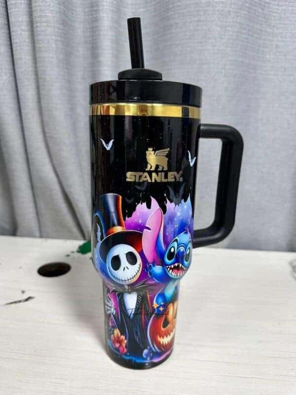Colorful Halloween-themed Stanley tumbler with spooky characters and bats.