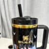 Stainless steel Stanley travel mug with unicorn illustration and gold trim for coffee.