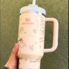 Insulated tumbler with bear and butterfly designs, perfect for hot or cold beverages.