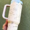 Cute animal-themed travel mug with positive quotes and whimsical sketches for daily inspiration.