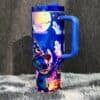 Colorful Halloween-themed travel mug with ghosts, pumpkins, and Stitch in a witch hat.