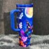 Bright Halloween-themed travel mug with stitched Handle.