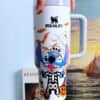 Colorful Stitch Halloween character mug with spiderweb and bats design.