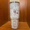 Decorative travel tumbler featuring peace, moon, and star designs.