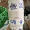 Adorable Stitch and Lilo characters on a wrapping paper design.