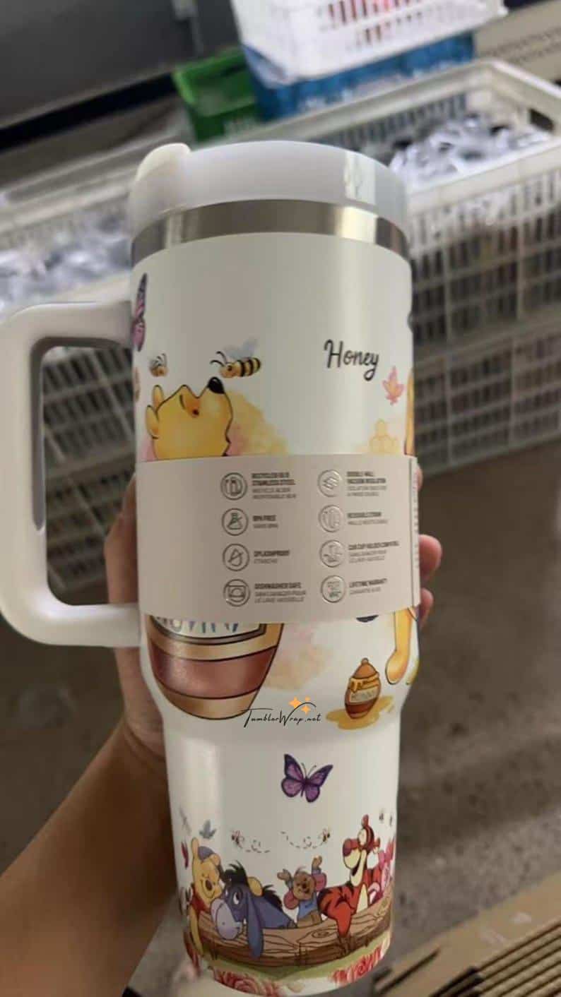 Colorful honey and bee themed travel mug with cartoon animals and flowers.