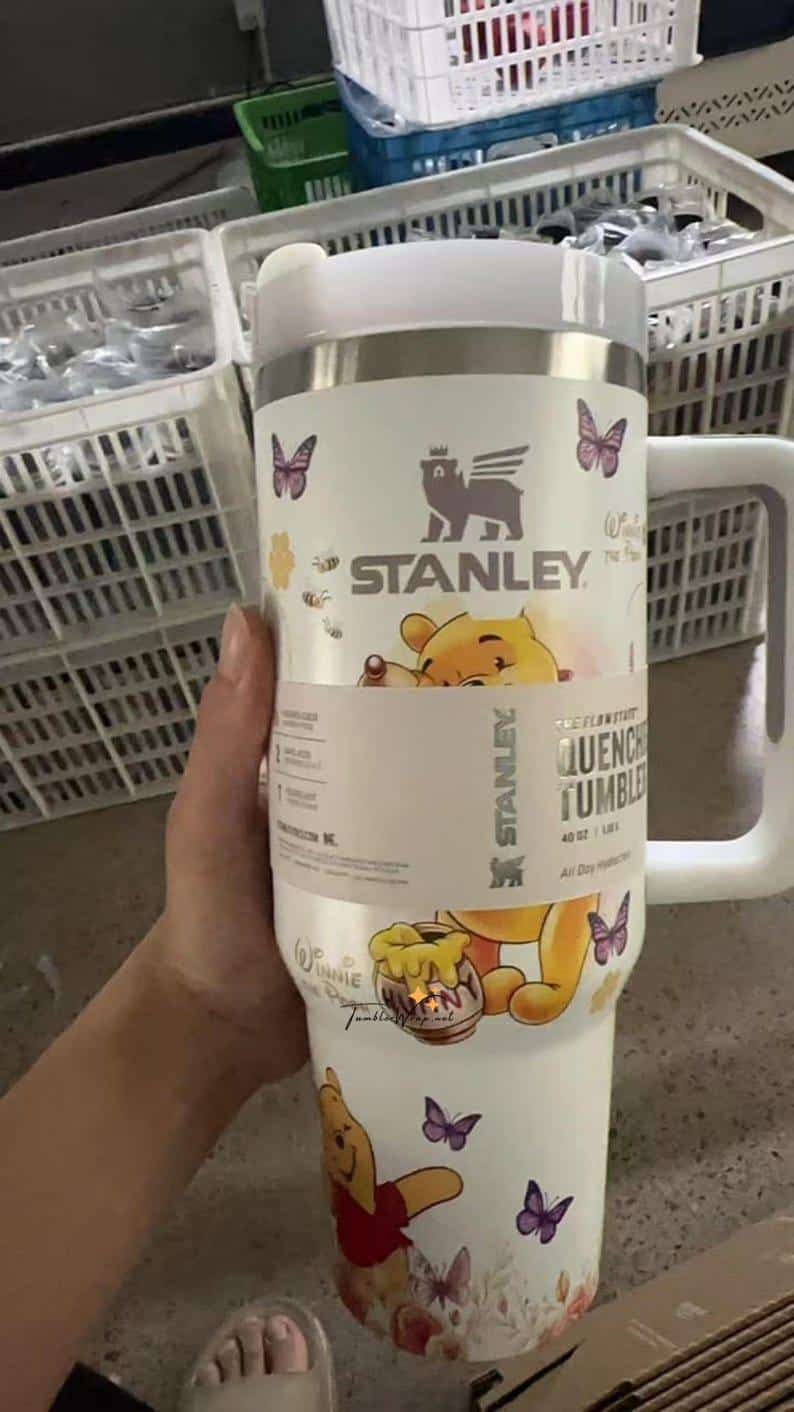 Stylish Stanley tumbler with Winnie the Pooh and butterfly designs.