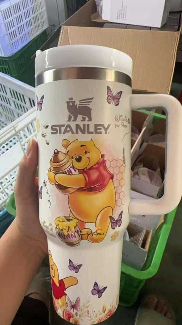Cute Winnie the Pooh mug with butterflies and honey jars.