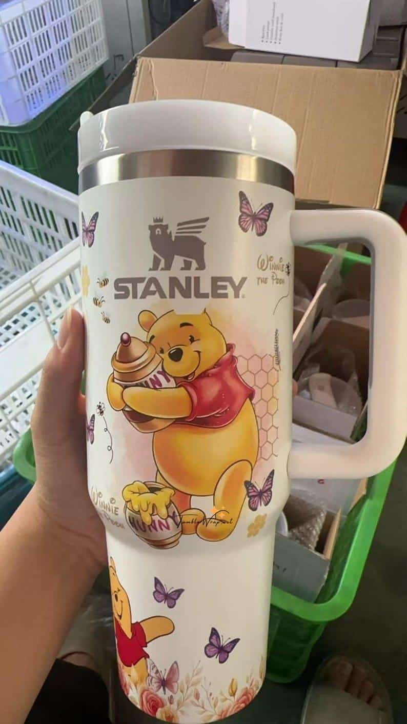 Cute Winnie the Pooh mug with butterflies and honey jars.