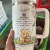 A white insulated Stanley thermos with bear illustration and inspirational quote.