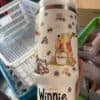 Cute Winnie the Pooh themed insulated stainless steel tumbler with bee and flower illustrations.
