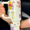 Whimsical Winnie the Pooh travel mug with Disney characters and cute animal illustrations.